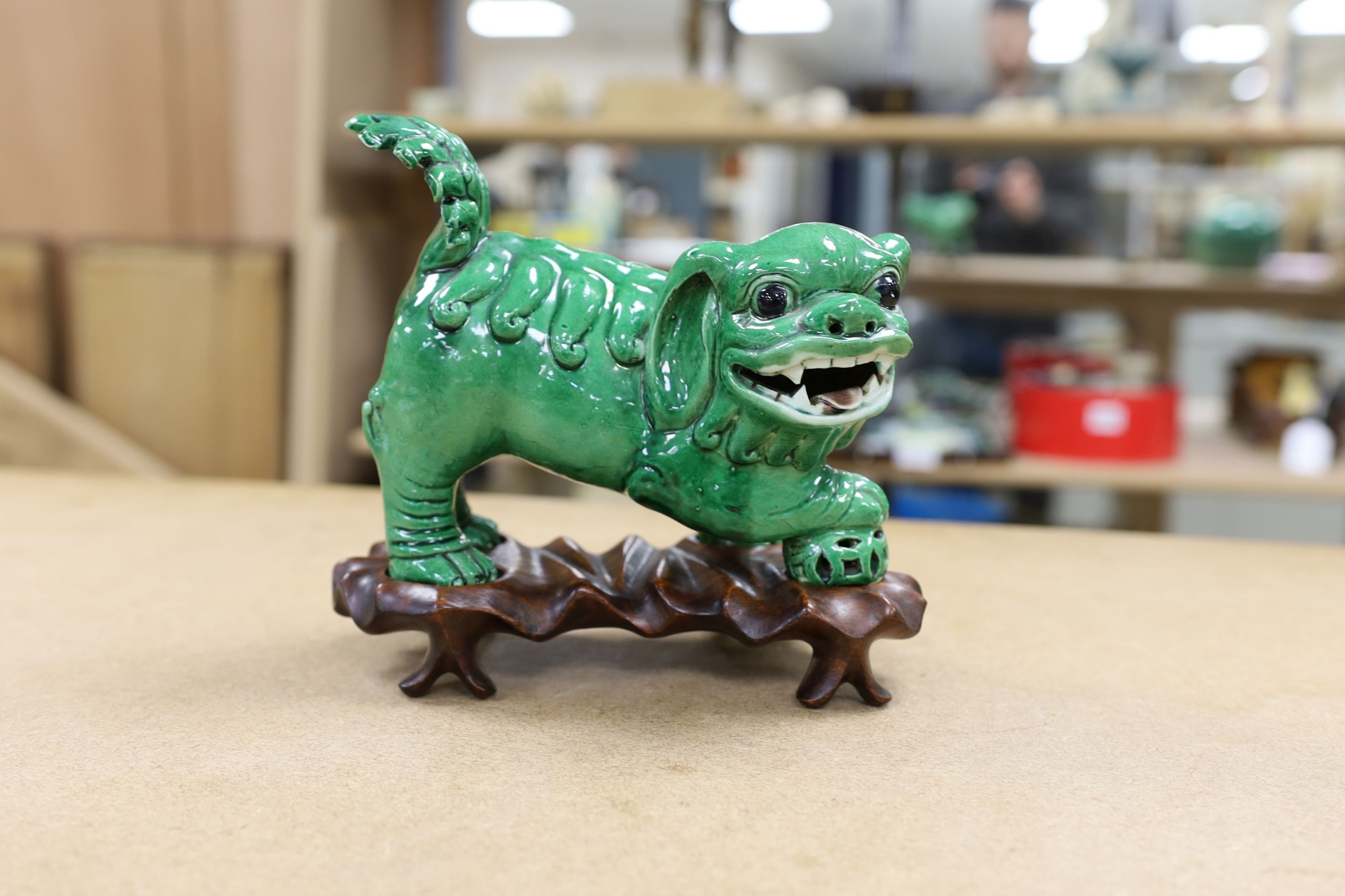 A 19th century Chinese green glazed model of a lion-dog, and two green crackle glaze jars, tallest 16cm